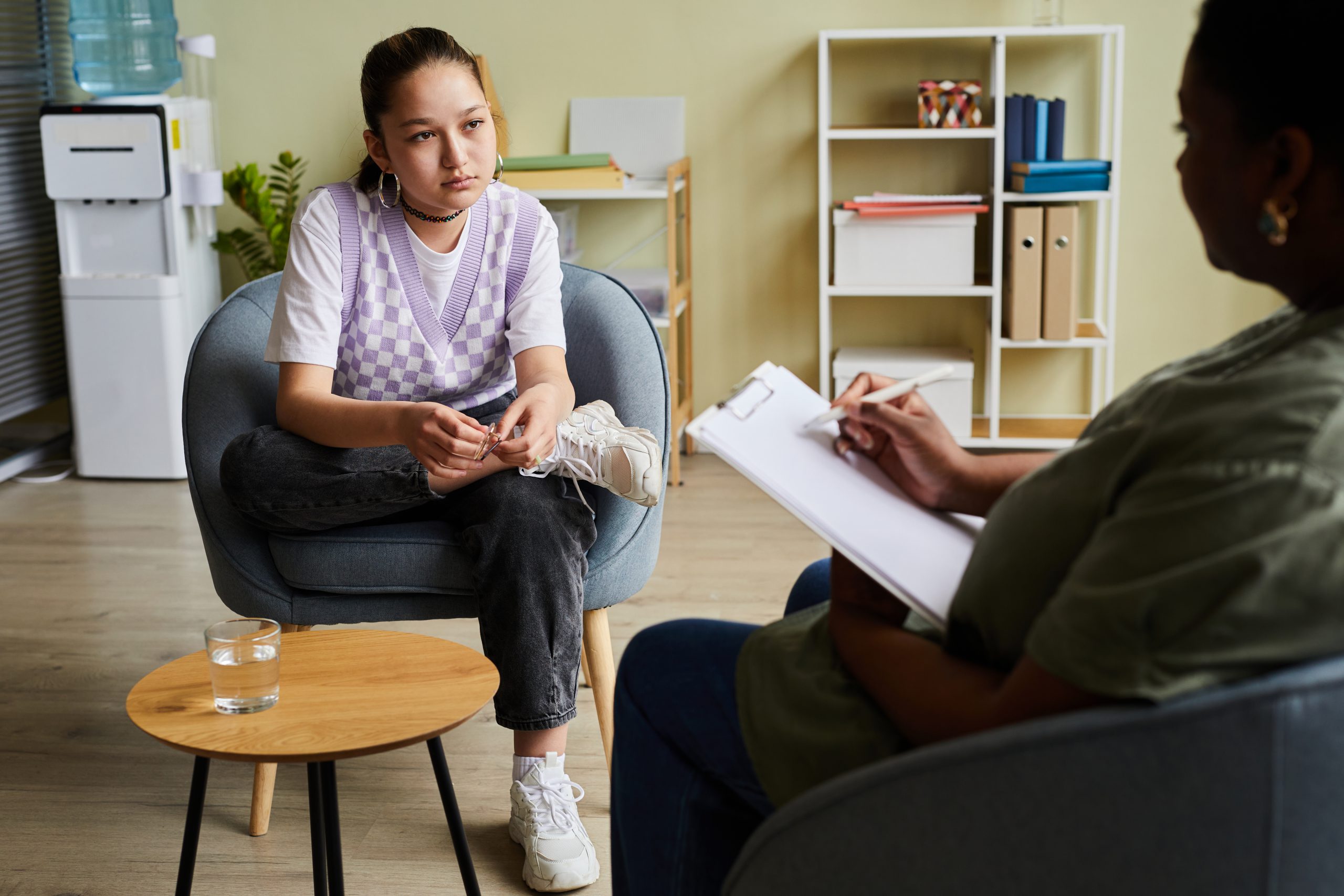 Girl having consultation with psychologist